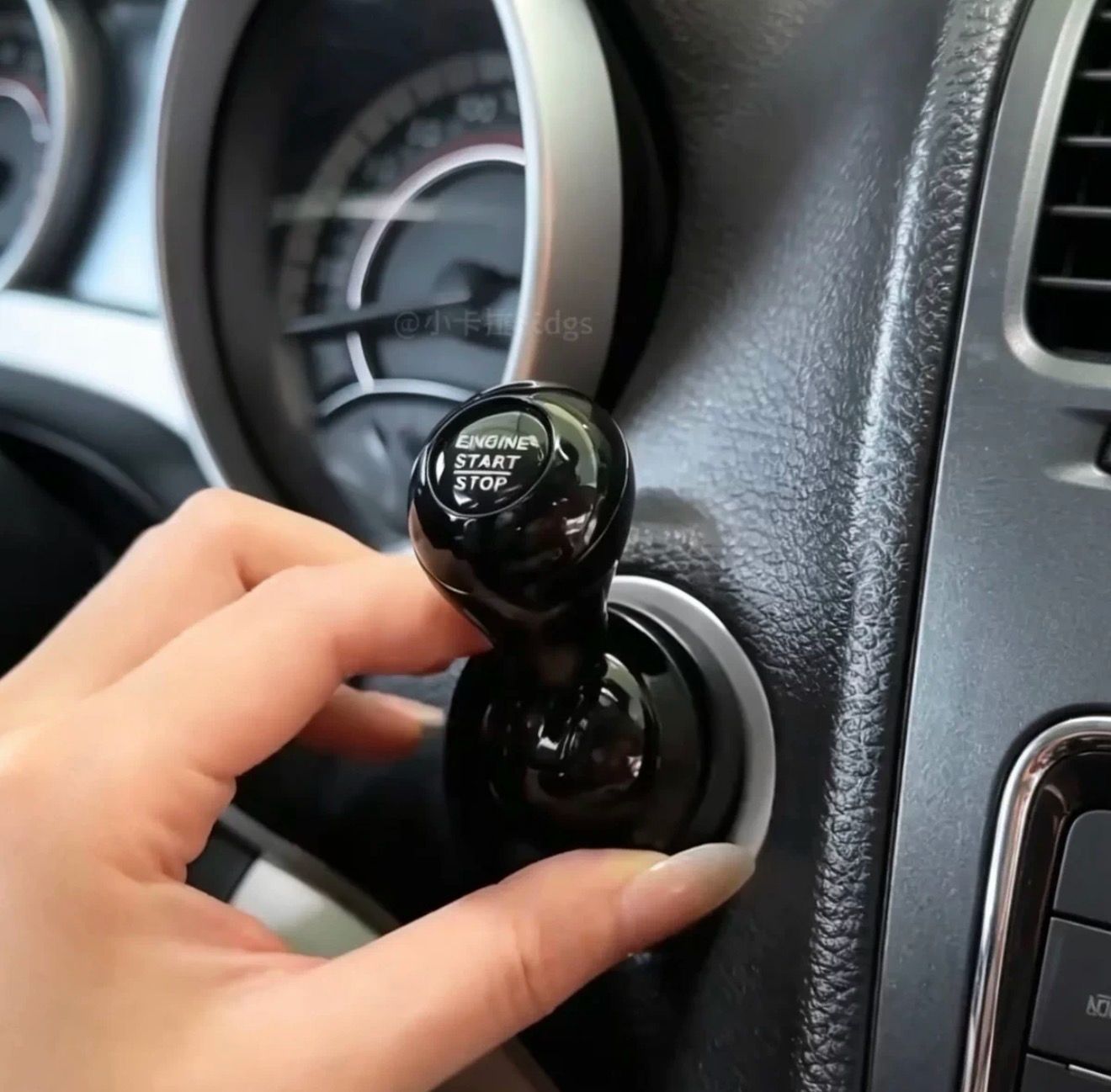 A hand inserts the Car Start / Stop Button Joystick, a gear shift-shaped key with "ENGINE START STOP" printed on it, into the ignition—adding a stylish luxury upgrade to any modern car interior.
