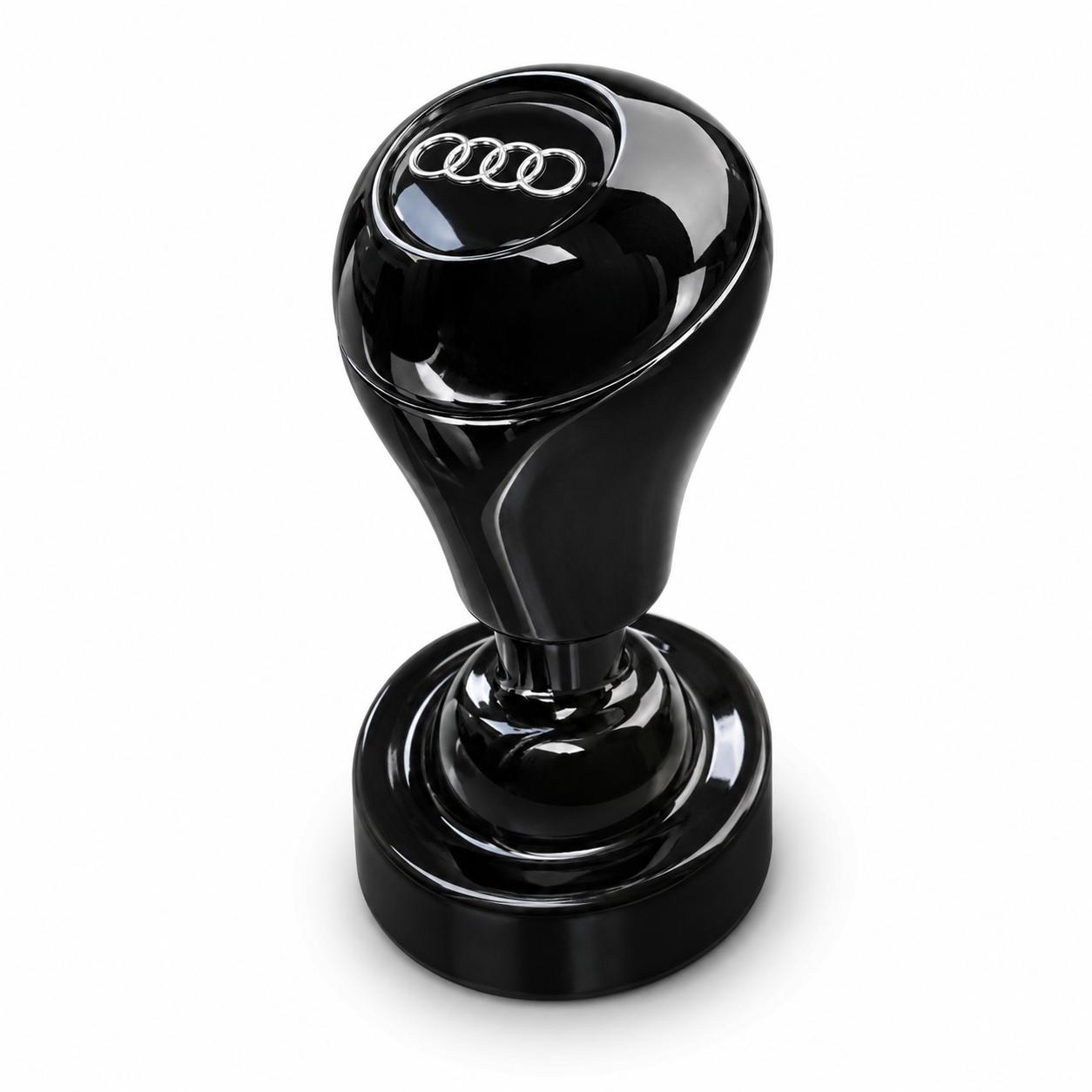The Car Start / Stop Button Joystick features a glossy black finish and the Audi logo with four interlocking rings, making it a stylish upgrade for any luxury car's interior. Set against a plain white background.